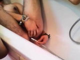 Bi-guy using shower head, squirting water, enema