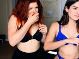 An amateur redhead lesbian is eating pussy from a brunette