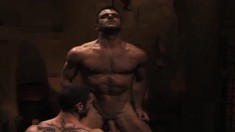 Ripped hunks have steamy oral and anal sex in a gay threesome in a crypt